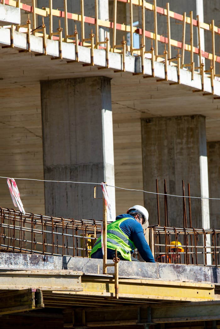 about-img Worker wearing safety gear at construction site, focused on tasks